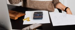 Woman using calculator how to pay your high energy bill